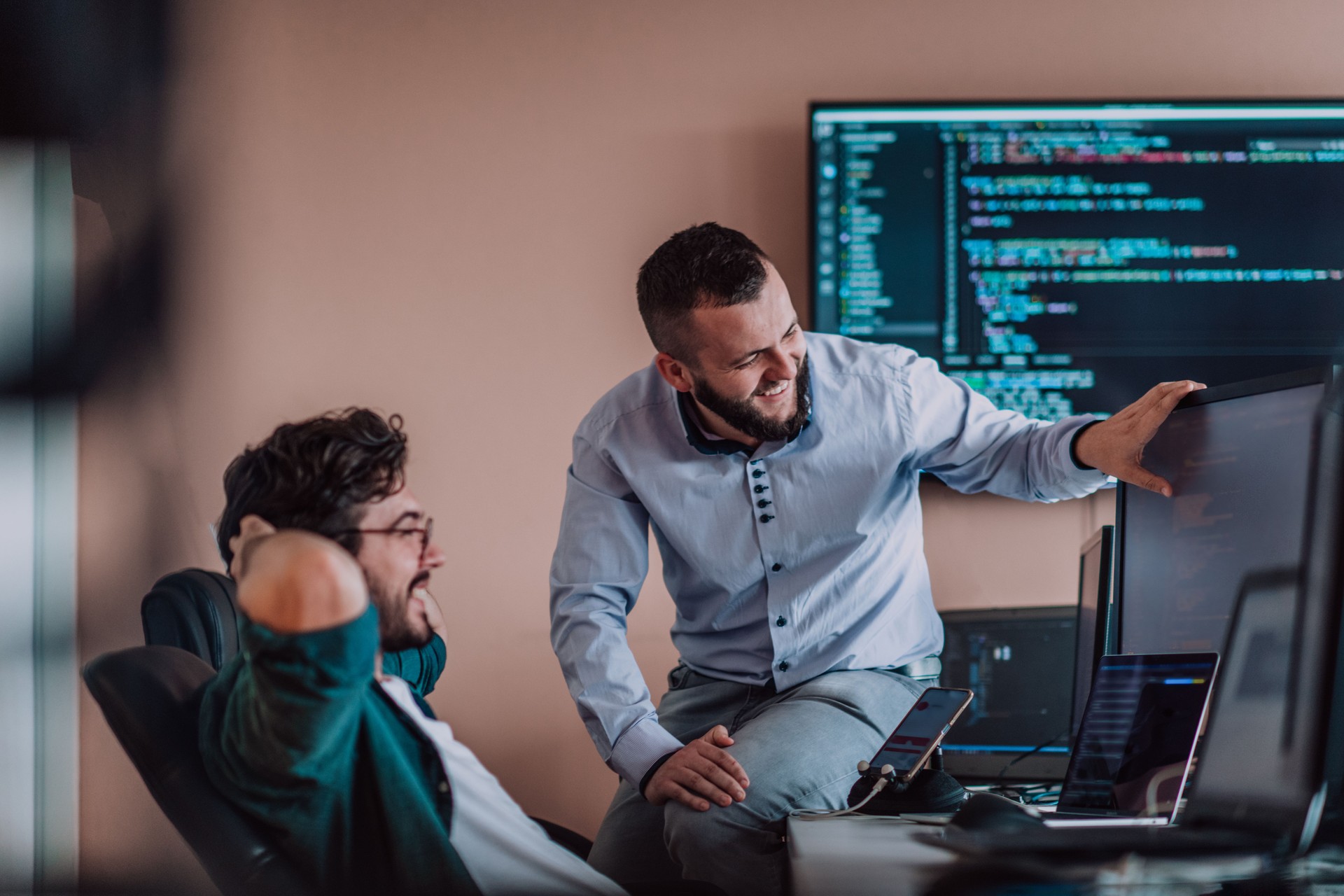 Programmers engrossed in deep collaboration, diligently working together to solve complex problems and develop innovative mobile applications with seamless functionality.